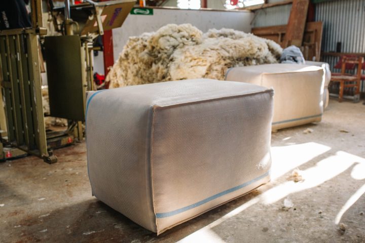 A pressed wool bale beside the press, from the Farmers Weekly article